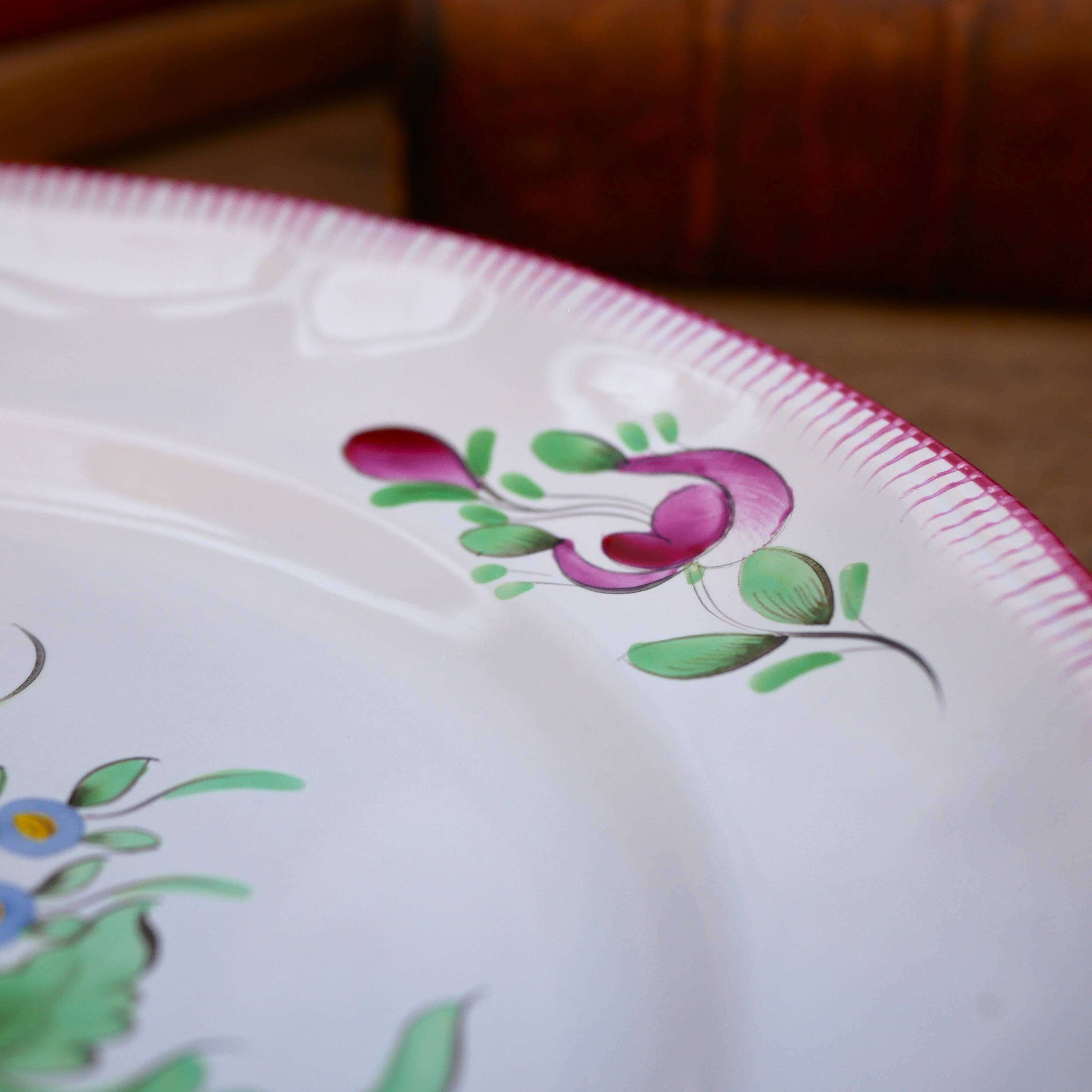 Three small hand-painted Saint-Clément dinner plates.