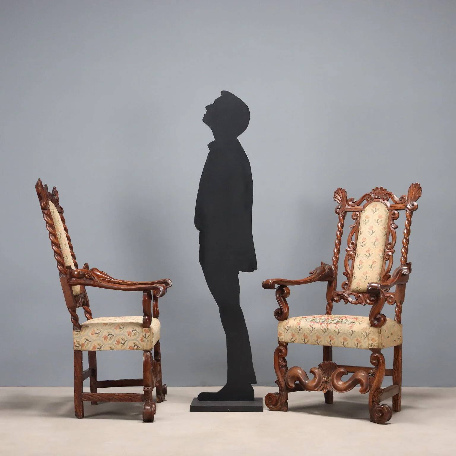 Pair of antique Baroque armchairs in walnut and fabric, Italy, 17th century.
