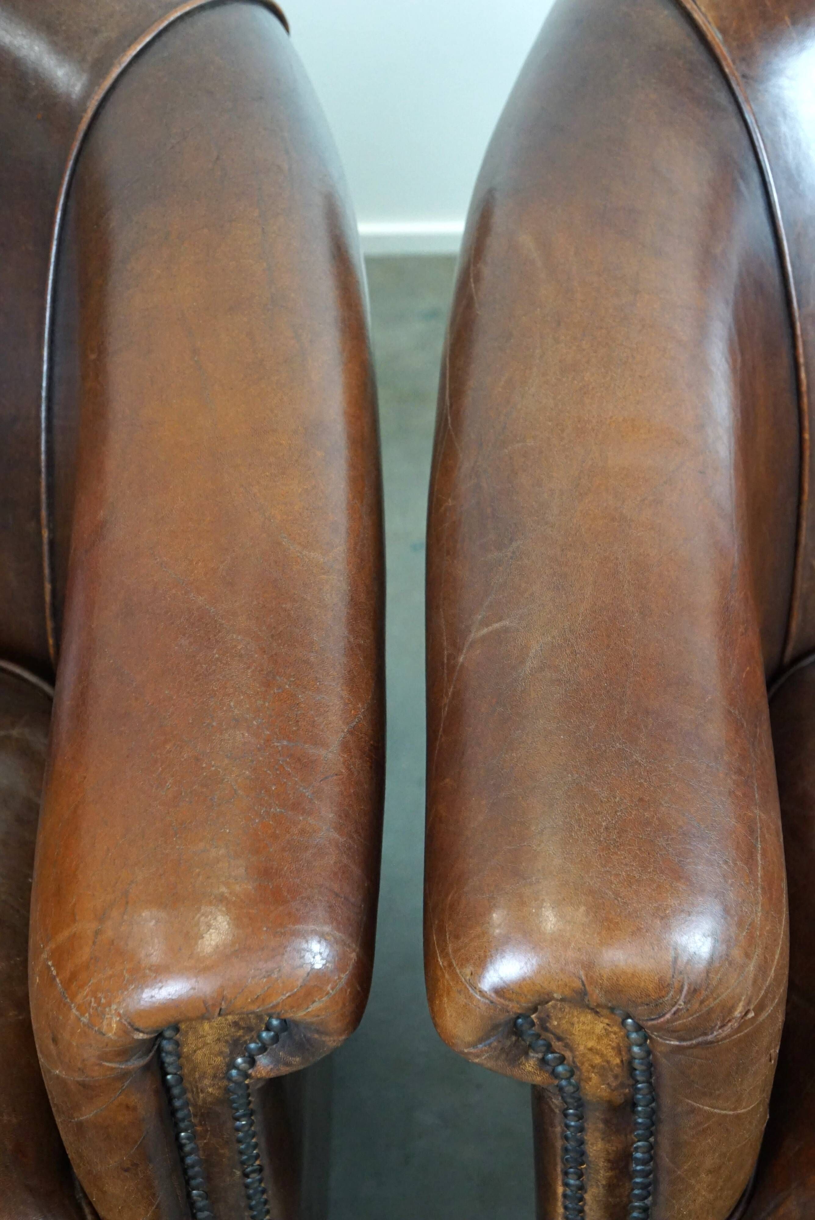 Set of two rugged sheep let of two rugged sheep leather club armchairs with a nice distressed look
