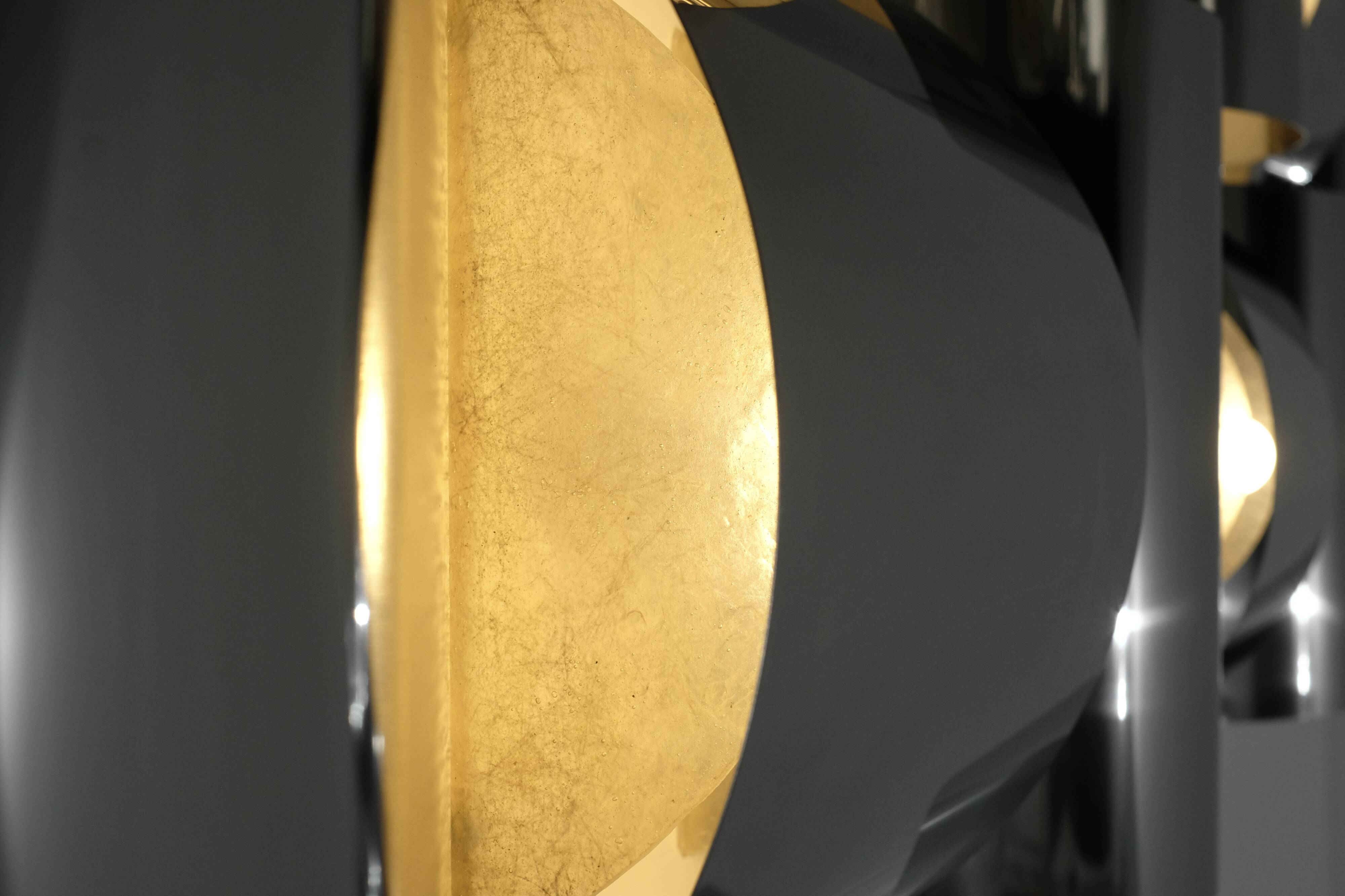 Contemporary wall light in stainless steel and metal.