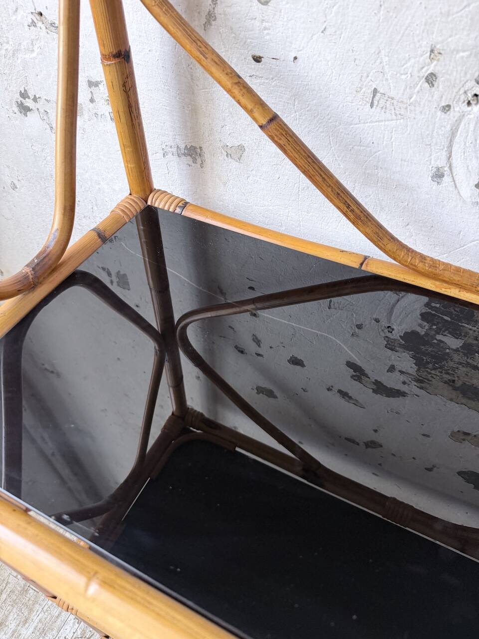 Rattan bookshelf and black glasses