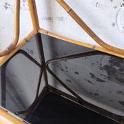 Rattan bookshelf and black glasses