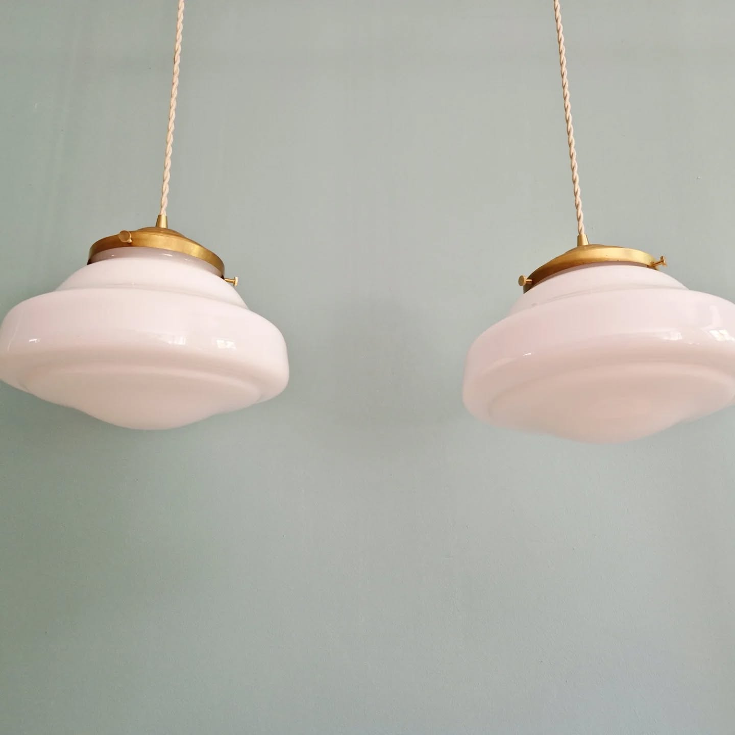 Pair of Art Deco pendant lights in white opaline.