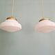 Pair of Art Deco pendant lights in white opaline.