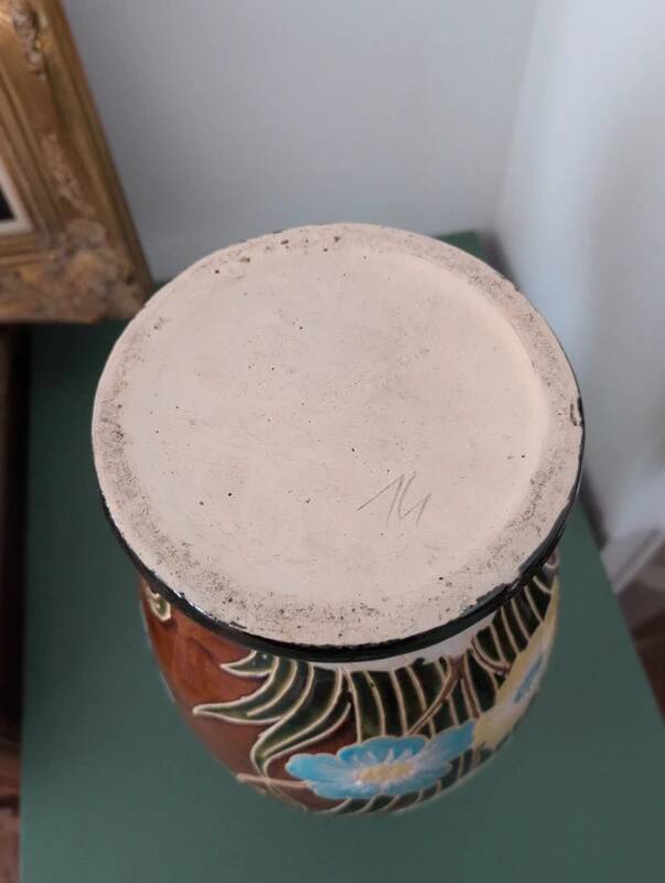 Large vintage antique vase with raised floral pattern.