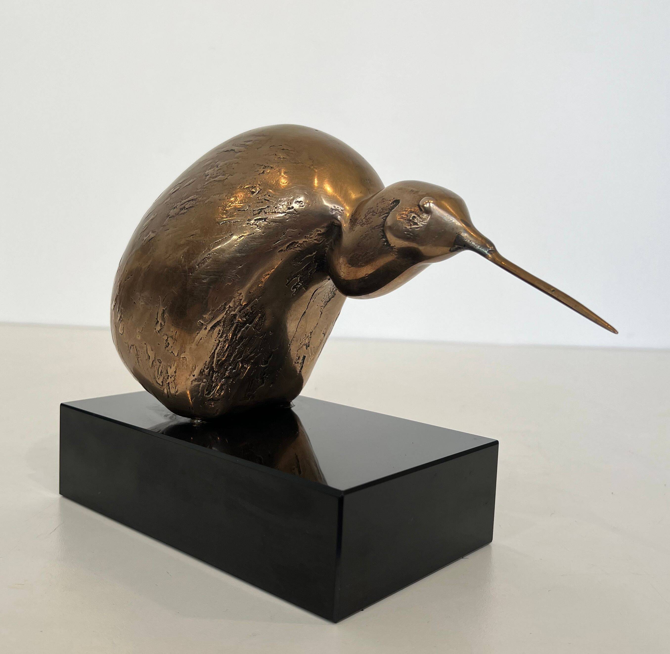 Bronze sculpture representing a stylised bird on a black marble base, signed and numbered.