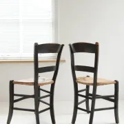 Pair of antique Northern French black-stained chairs with rush seats