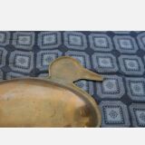 Empty brass pocket forming a duck