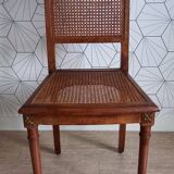 Chaise cannée art déco avec ornements en bronze.