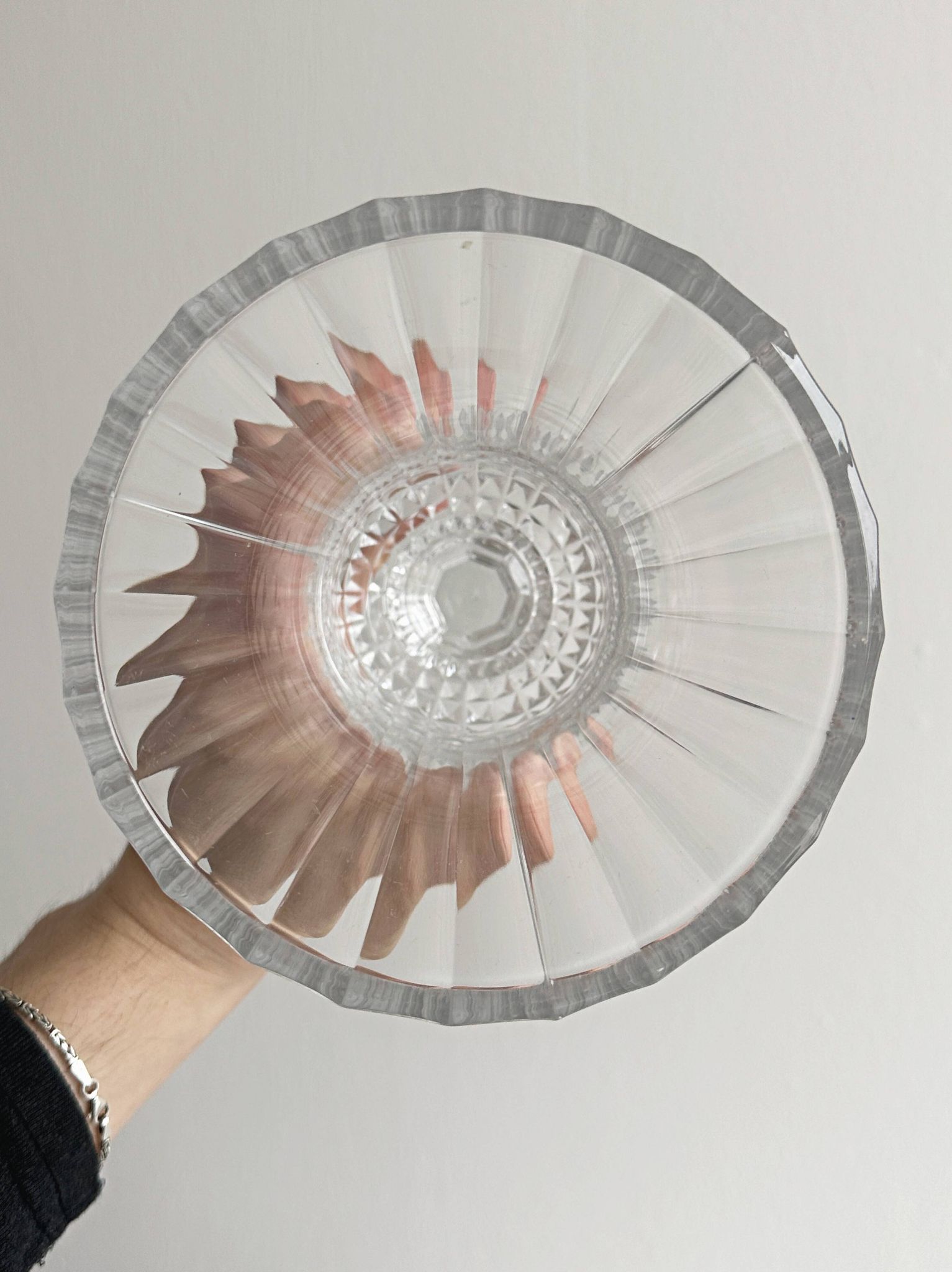Antique thick glass vase on a pedestal.