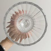 Antique thick glass vase on a pedestal.