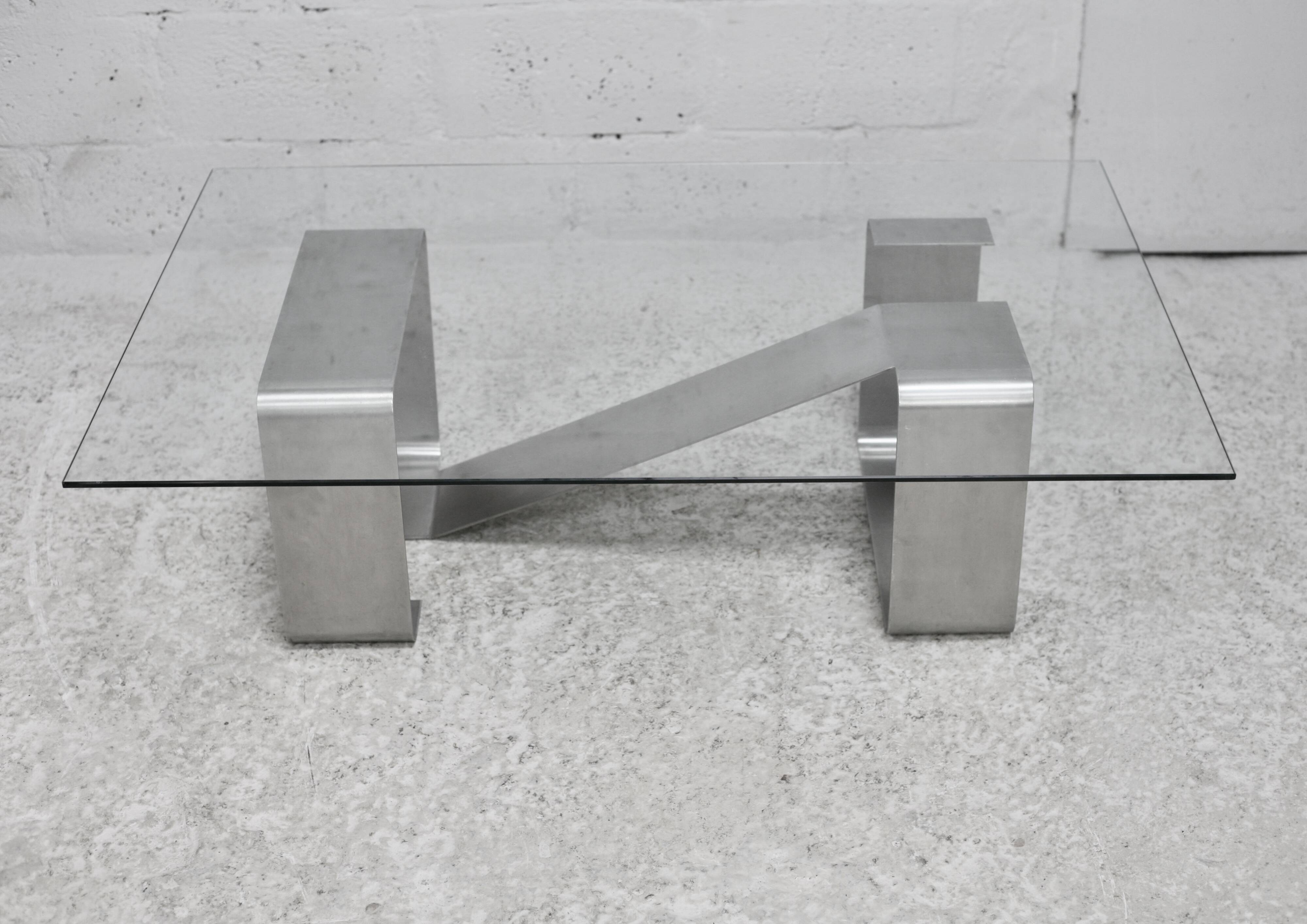 Coffee table with "kinetic" steel base and glass slab. Circa 1970.
