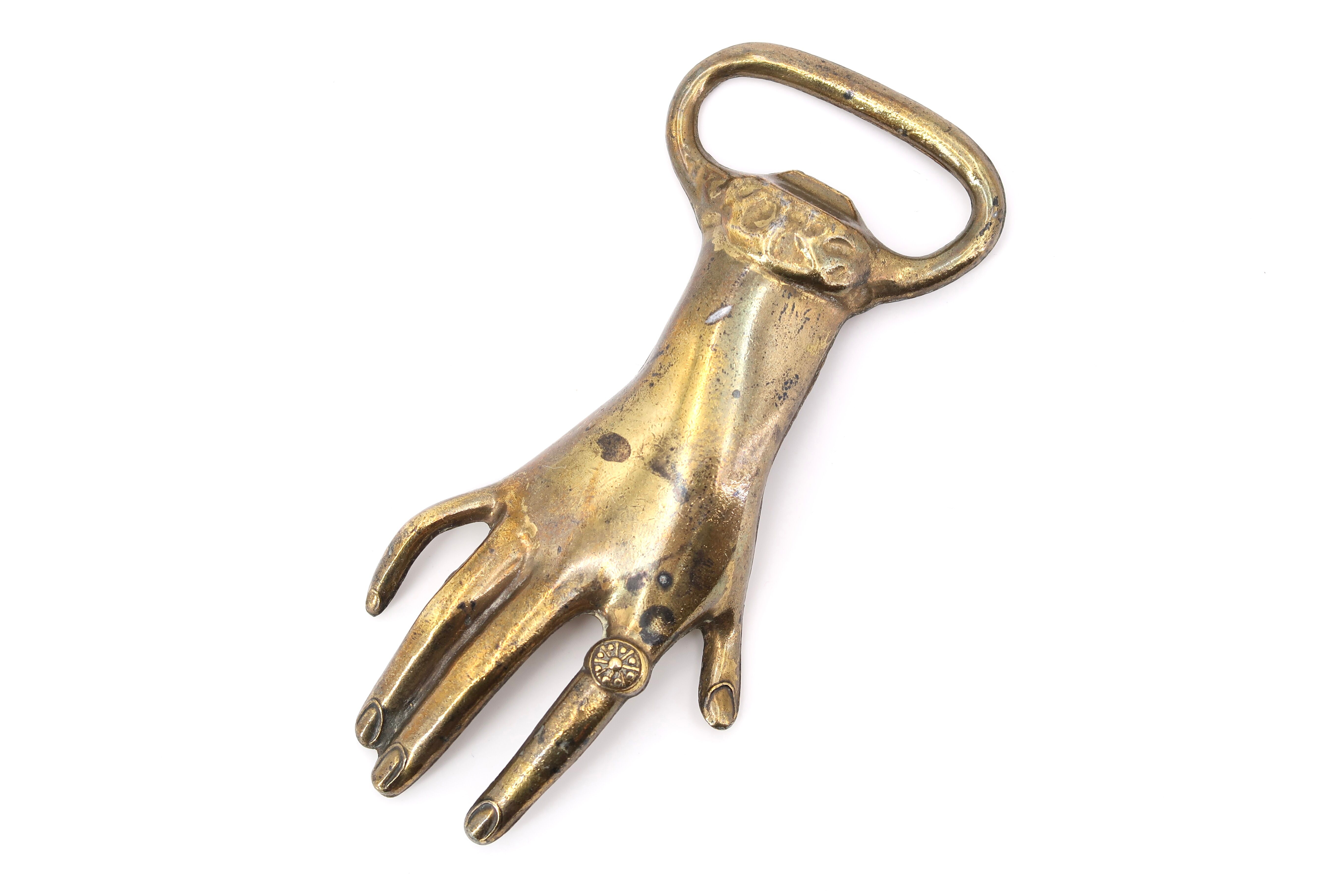 Brass hand bottle opener, 50s