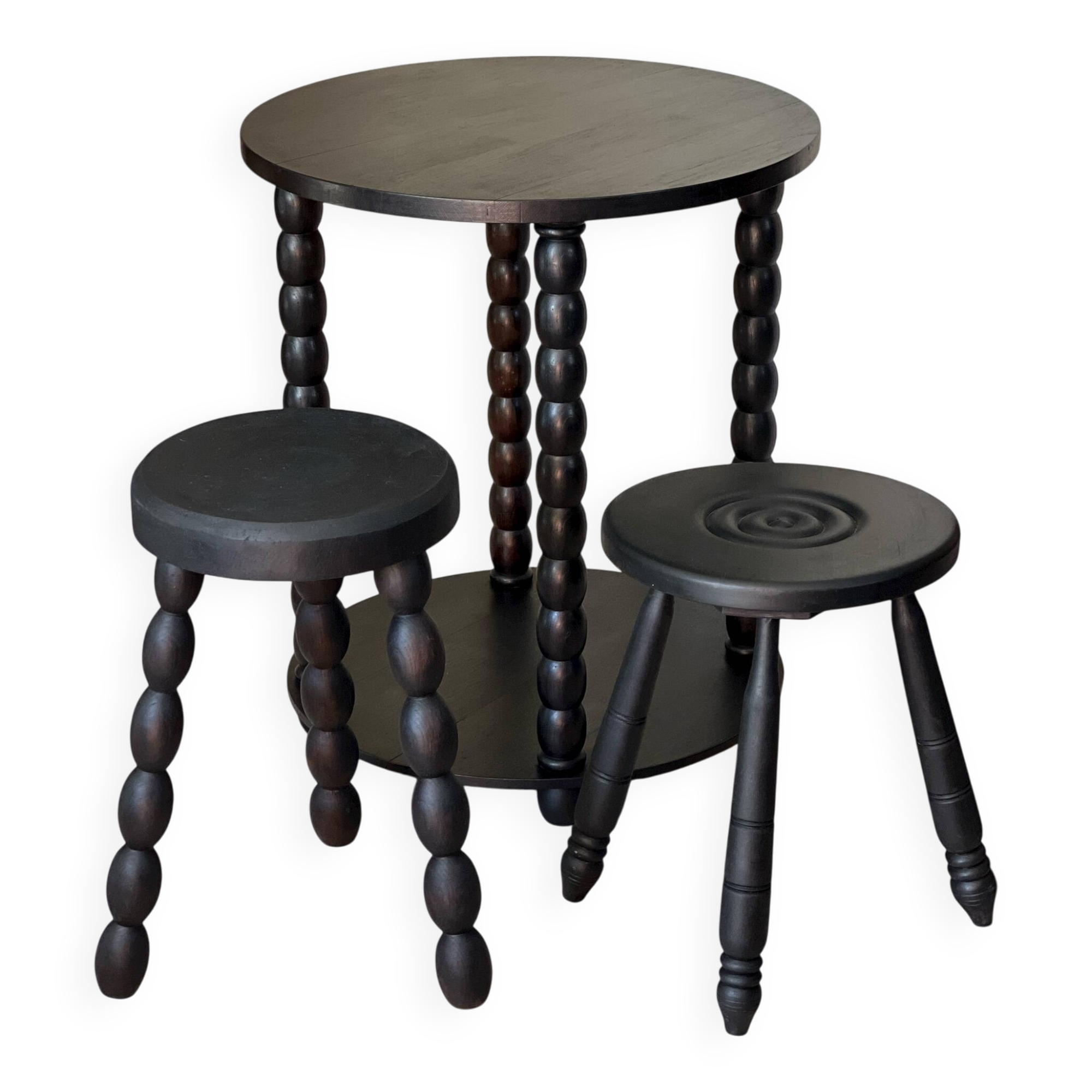 Set of side table and 2 stools, stained black wood, Circa 1950.