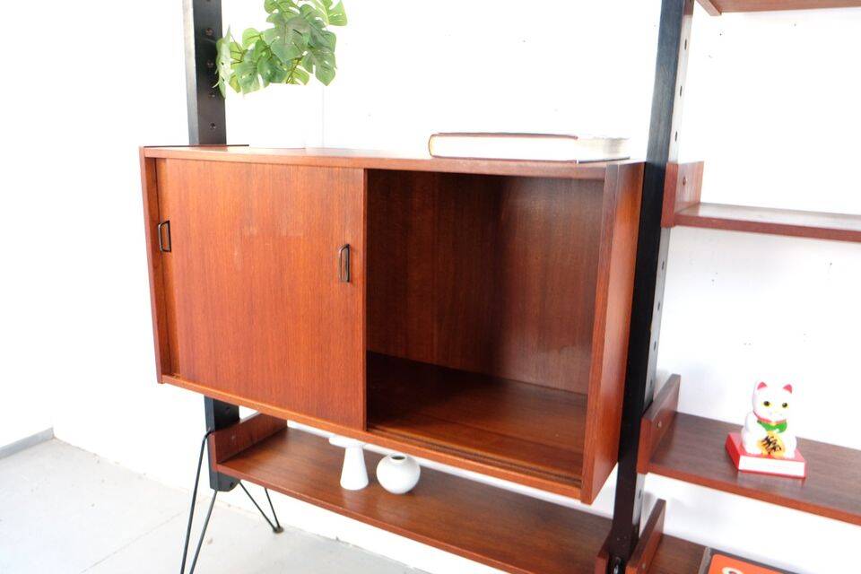 Vintage teak shelving system in 60s-70s style, retro style.