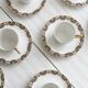 7 Limoges porcelain cups and saucers with gold decoration and floral motif.
