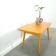 Vintage veneer table with pretty angular legs and brass at the base of the legs.