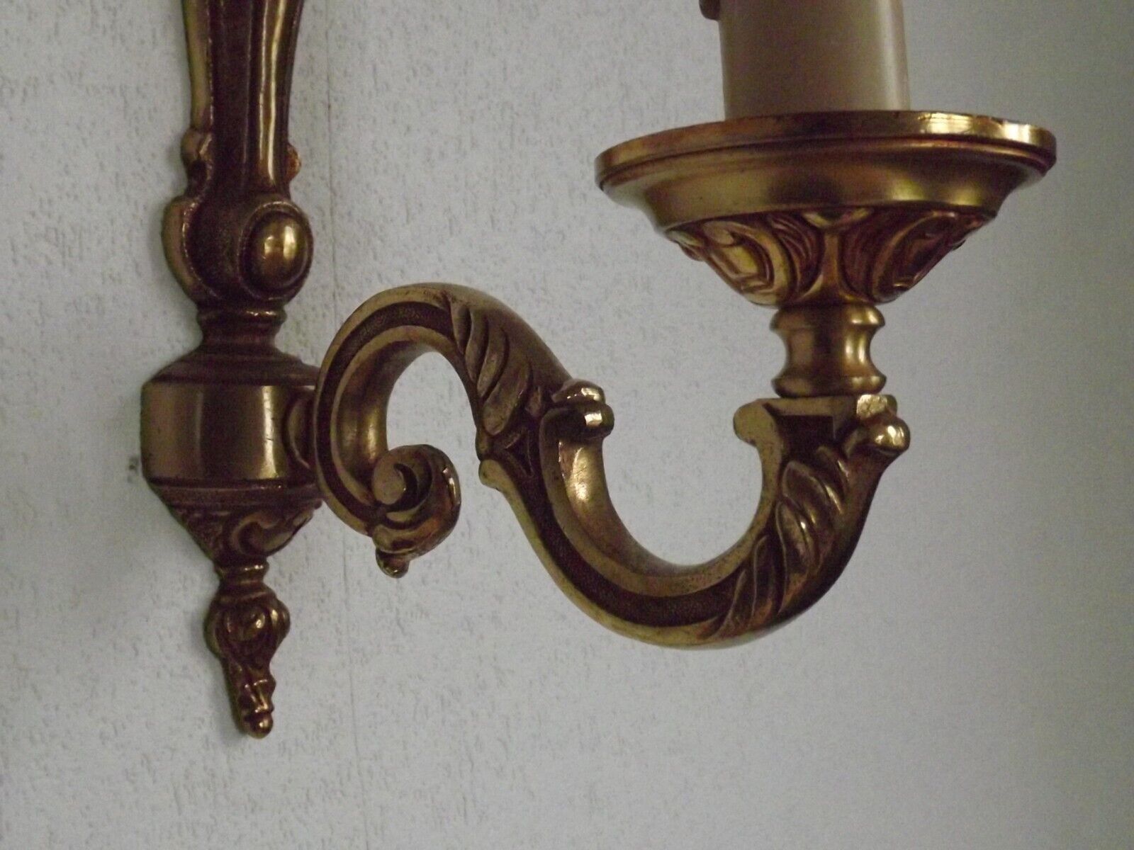 Simple wall sconce in classic Empire style in vintage French bronze.