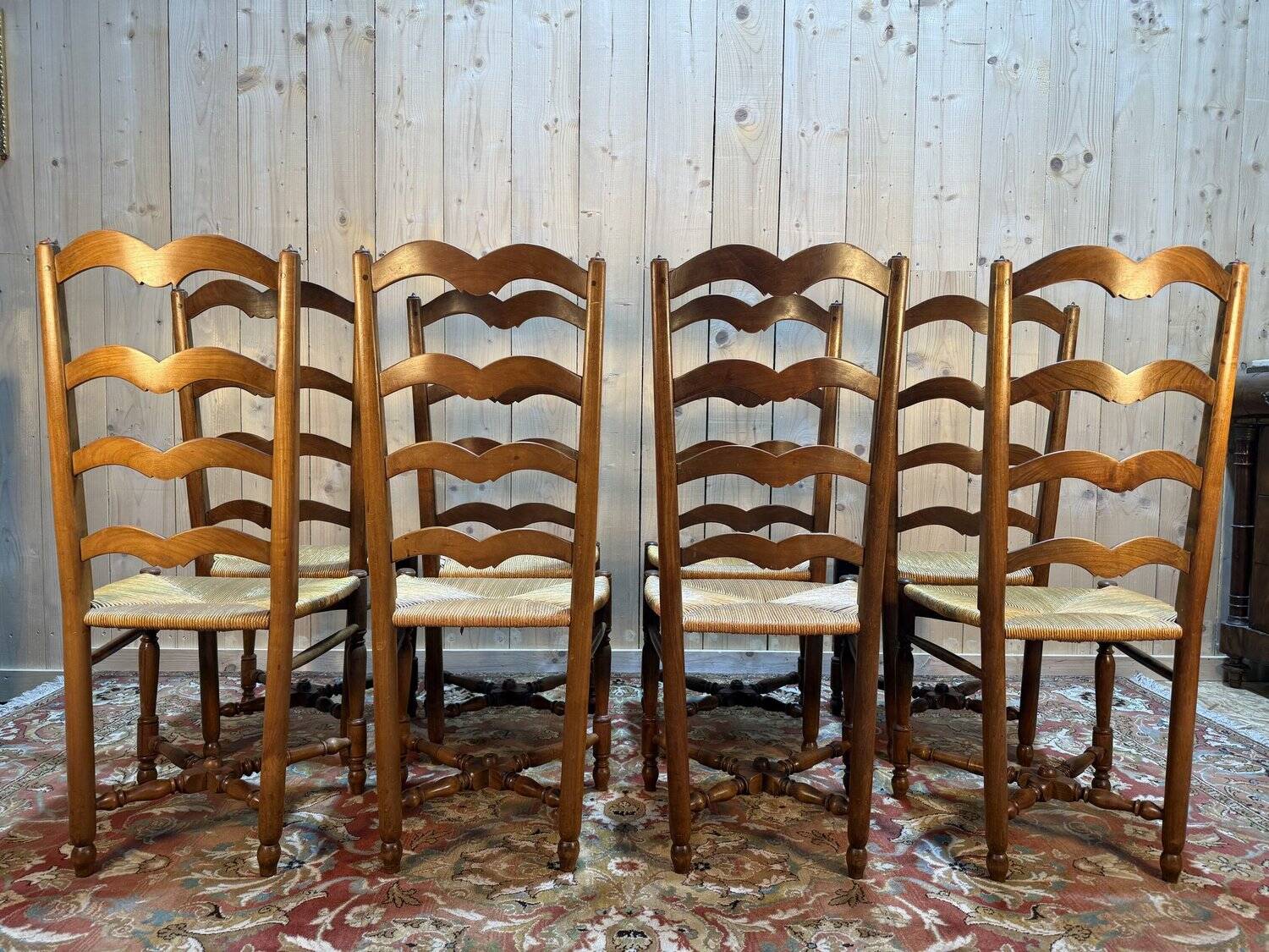 Set of 8 rustic high-back straw chairs.