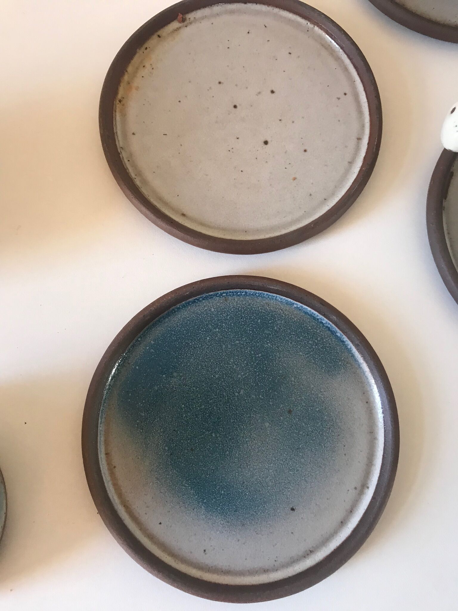 Lot 7 cups and saucers sandstone by Roger Jacques