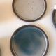 Lot 7 cups and saucers sandstone by Roger Jacques