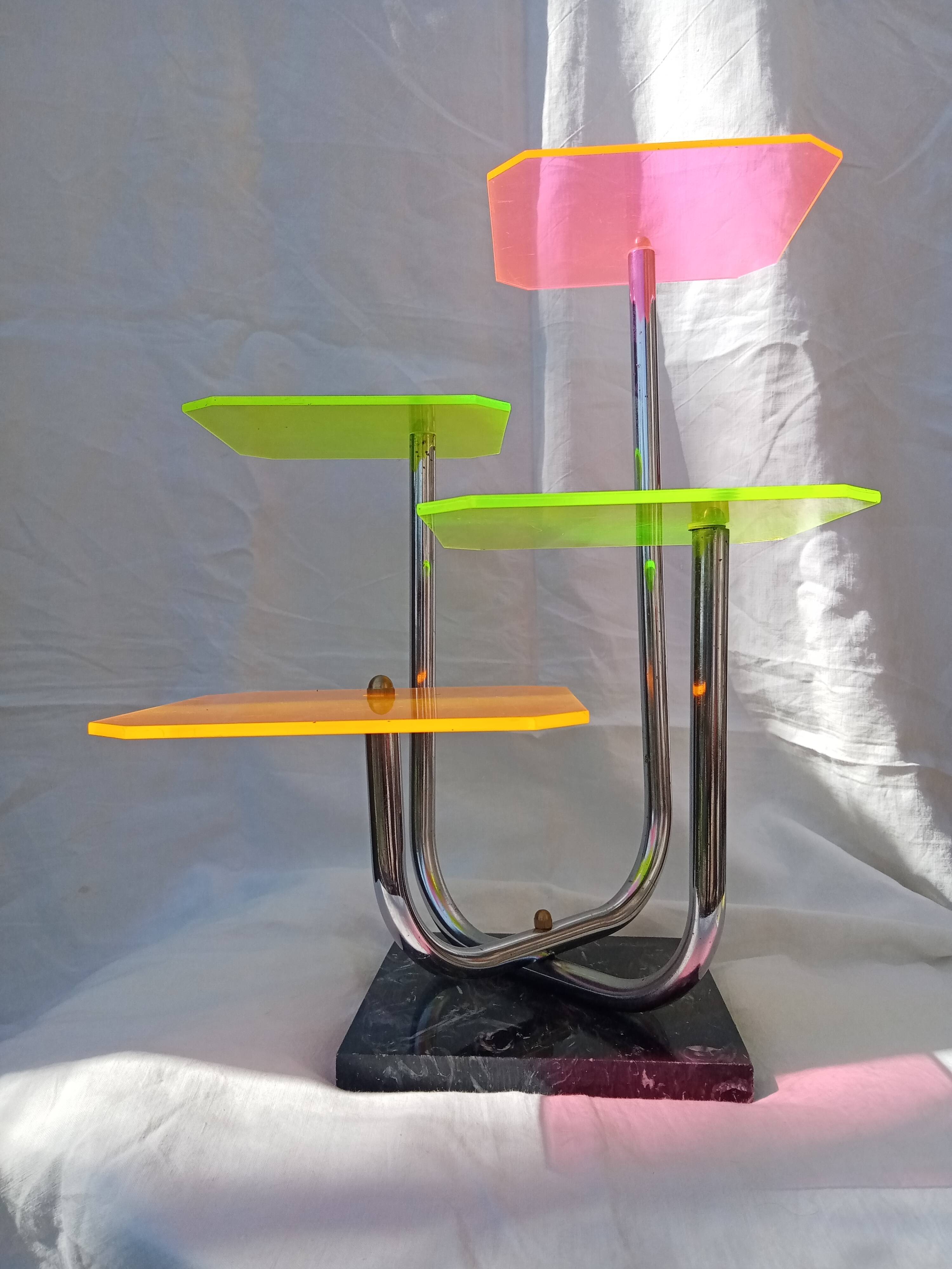 Display shelf with plexiglass trays in 1970s colours.