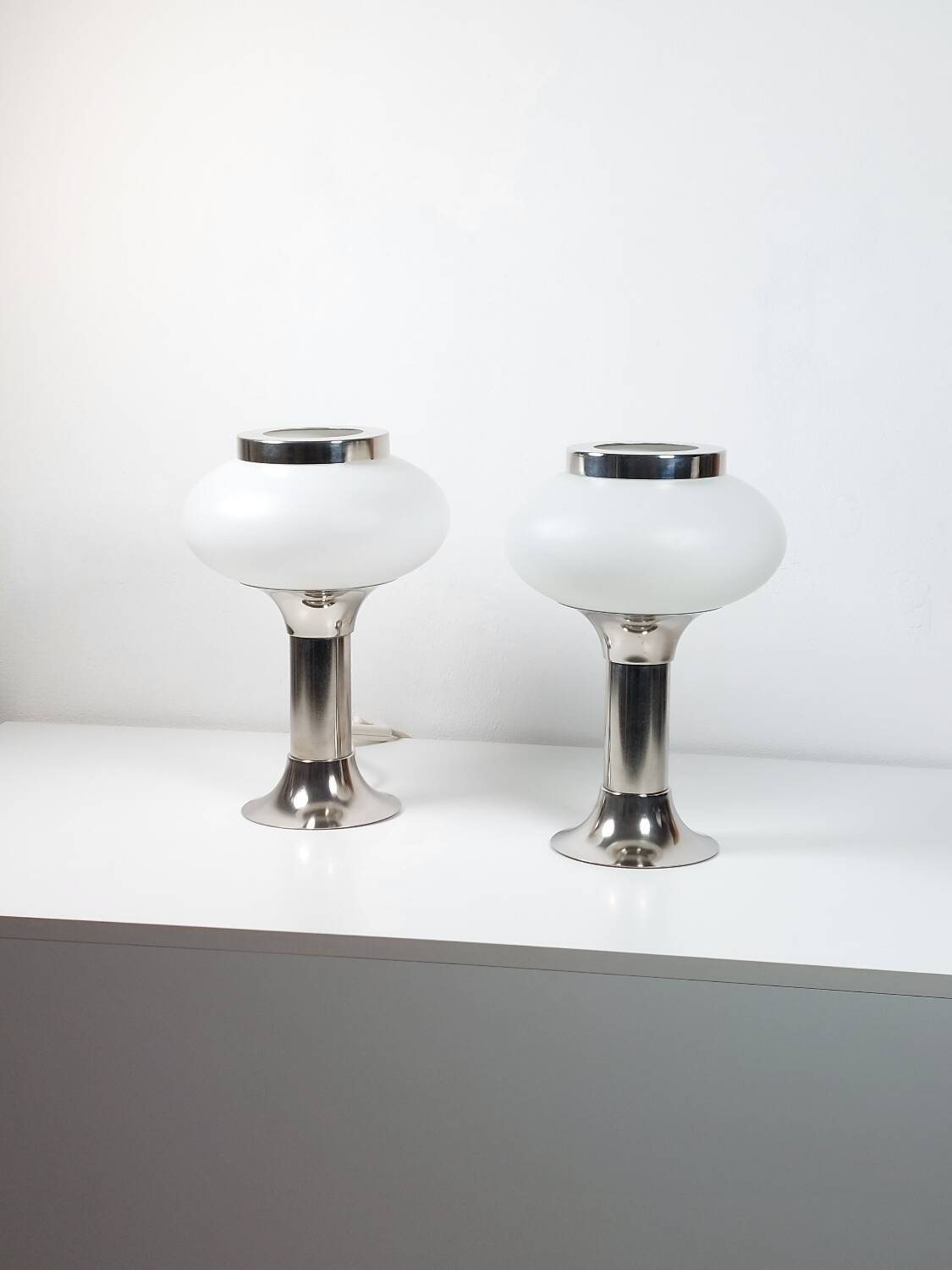 Pair of vintage futuristic style table lamps in chrome and opal glass.