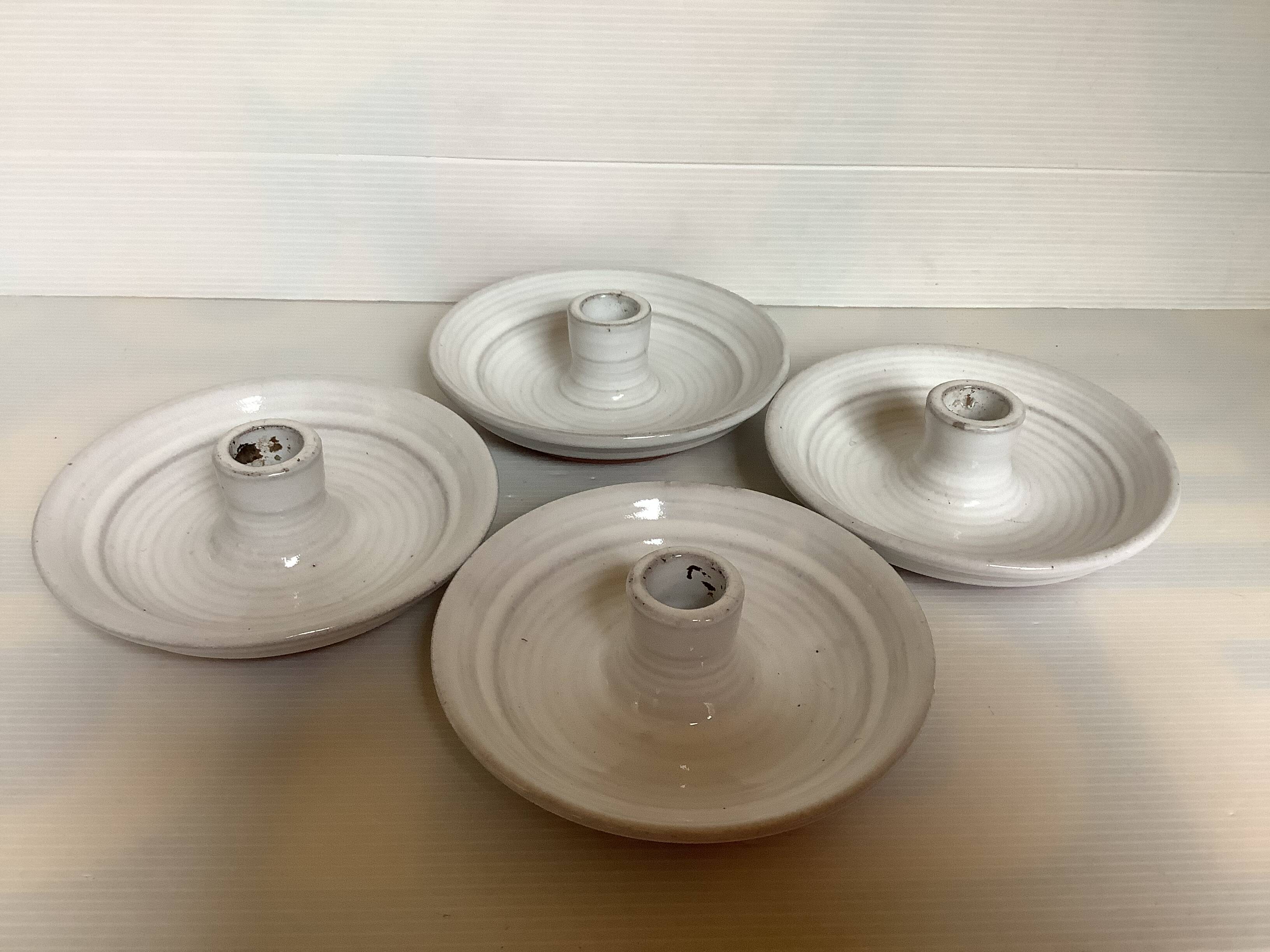 Four ceramic candle holders