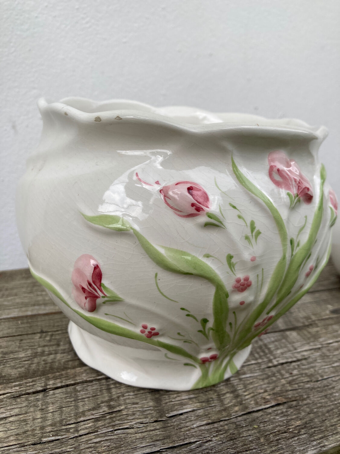 White ceramic pot cache in old flower slip