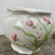 White ceramic pot cache in old flower slip