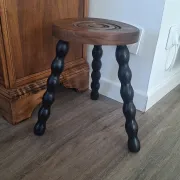 Brown and black wooden tripod stool