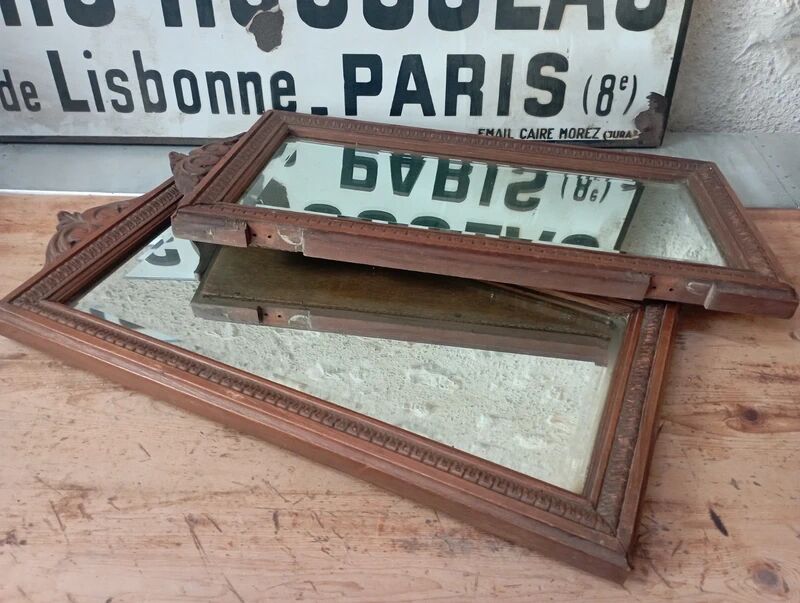 Set of two bevelled mirrors in moulded oak.