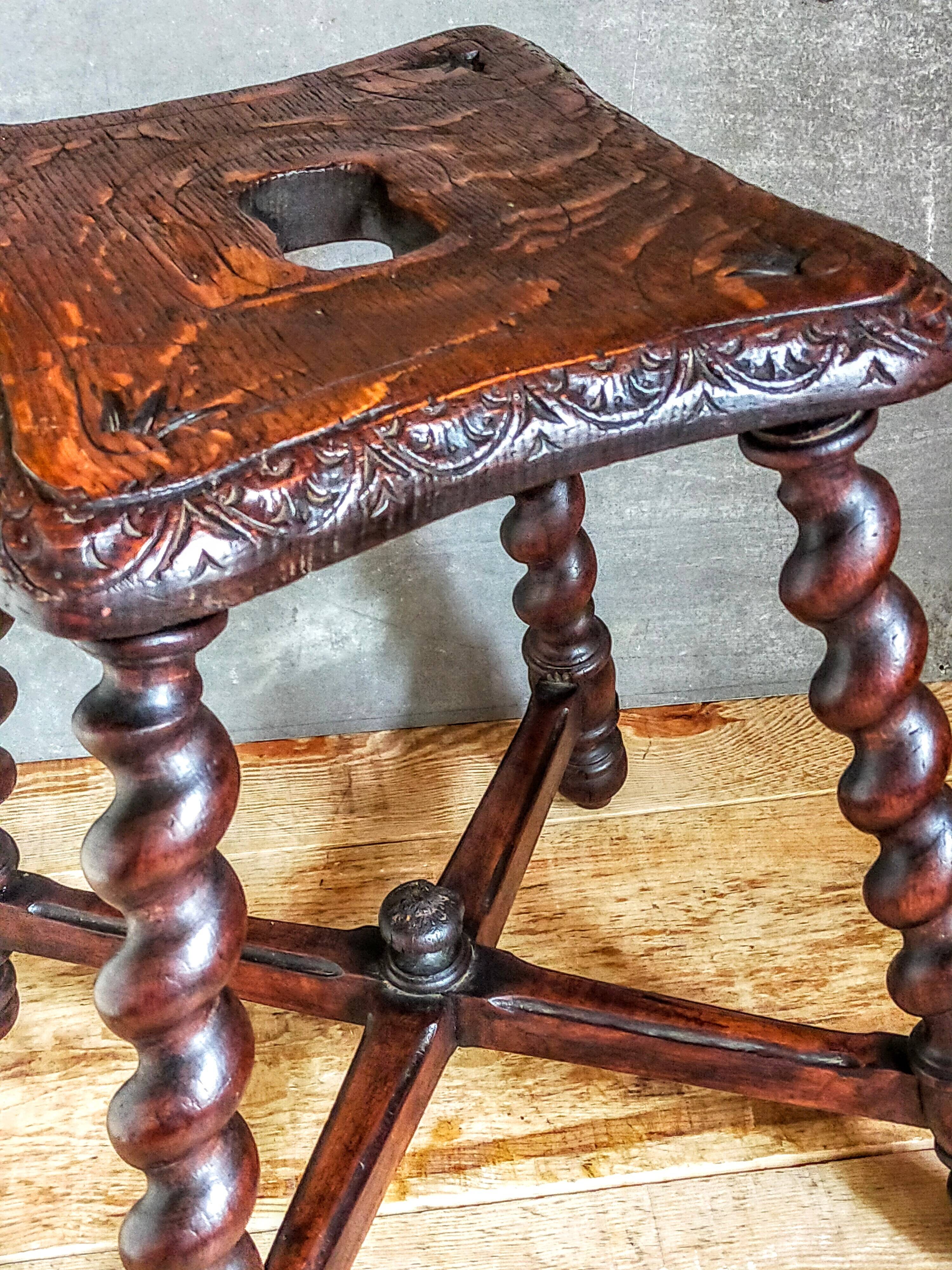 Antique stool in turned and carved solid wood