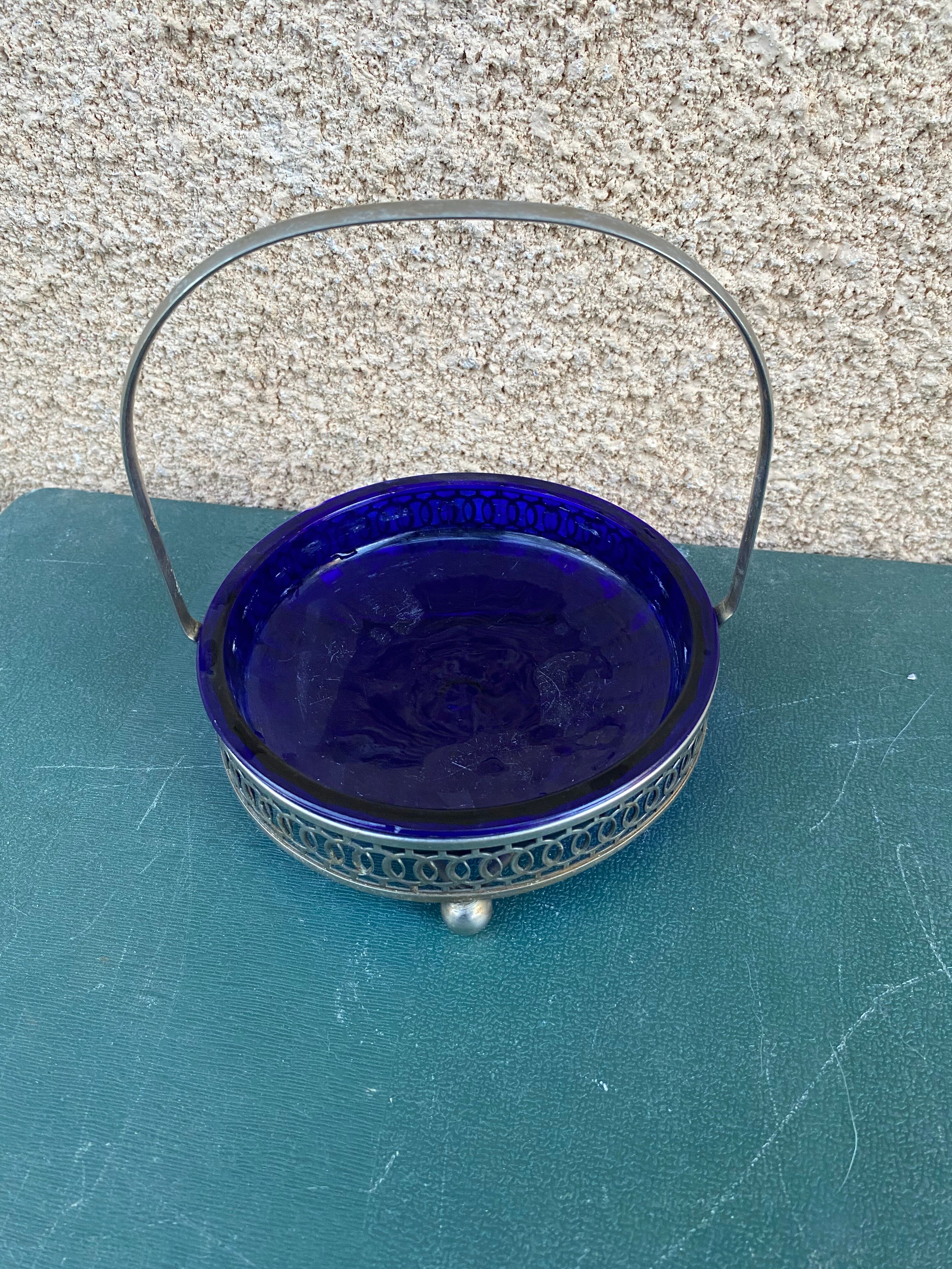 Vintage table basket in cobalt blue glass with a silver metal frame.