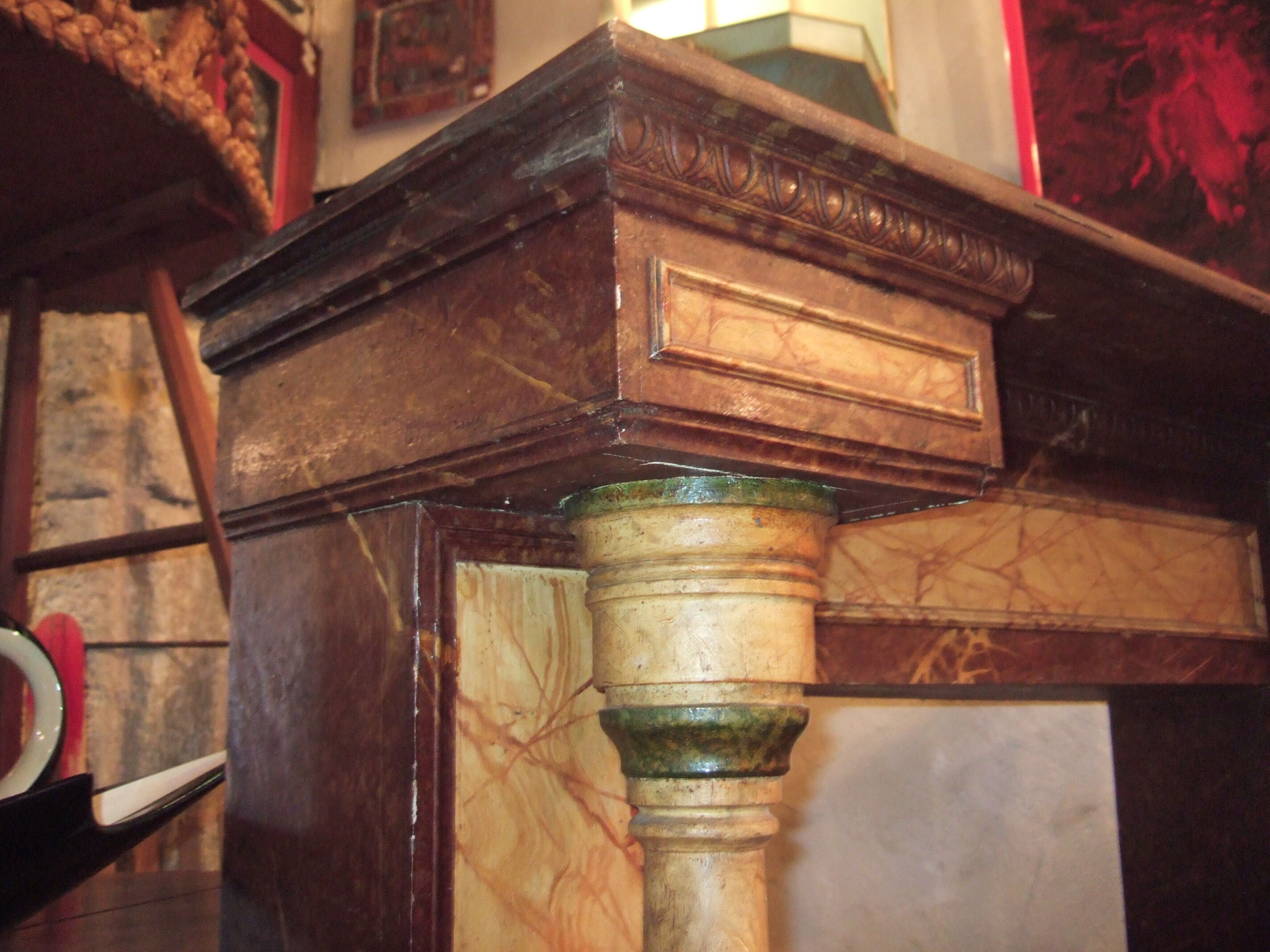 19th century wooden fireplace, faux marble paint. Can act as a console.