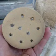 Beige stoneware cheese drainer