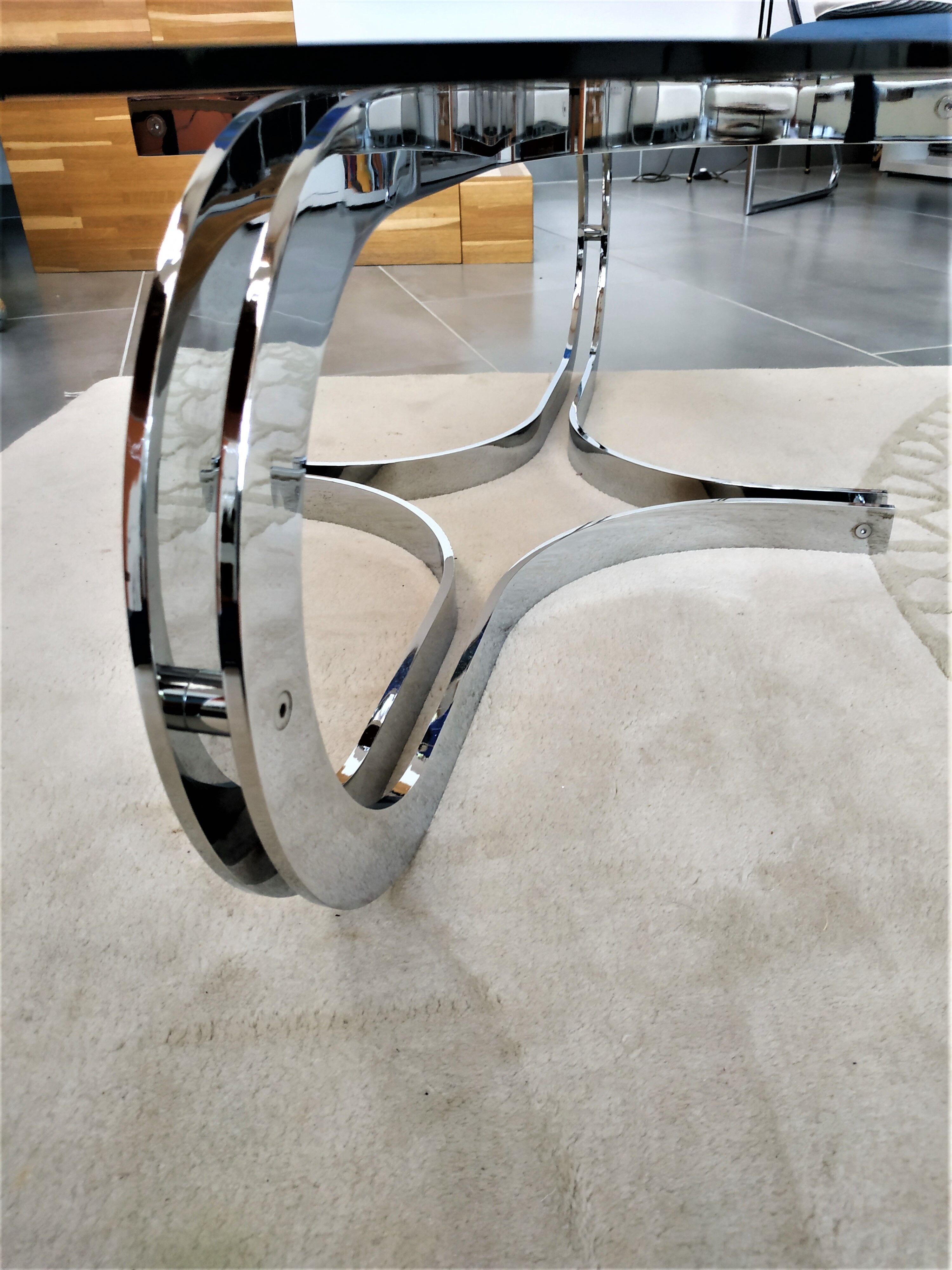 Chrome metal coffee table and oval smoked glass tray
