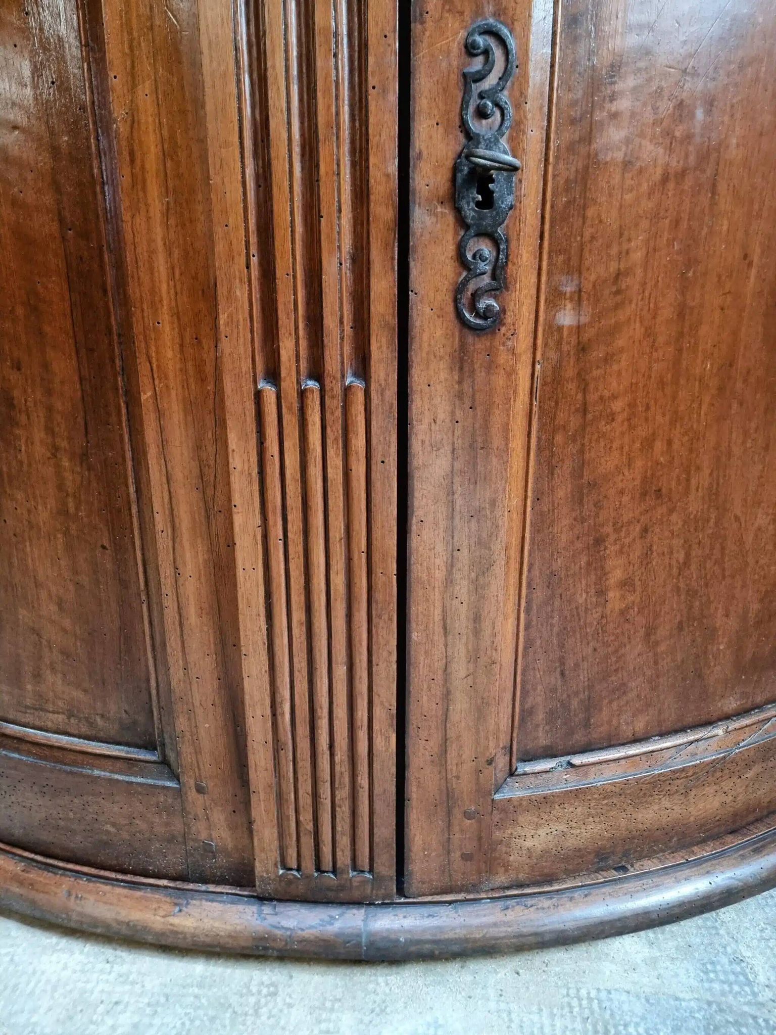 Antique demi-lune cabinet in walnut, late 18th century, French château.