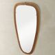 Wonderful 1950s mirror on a teak wood panel with brass frame. Made in Germany