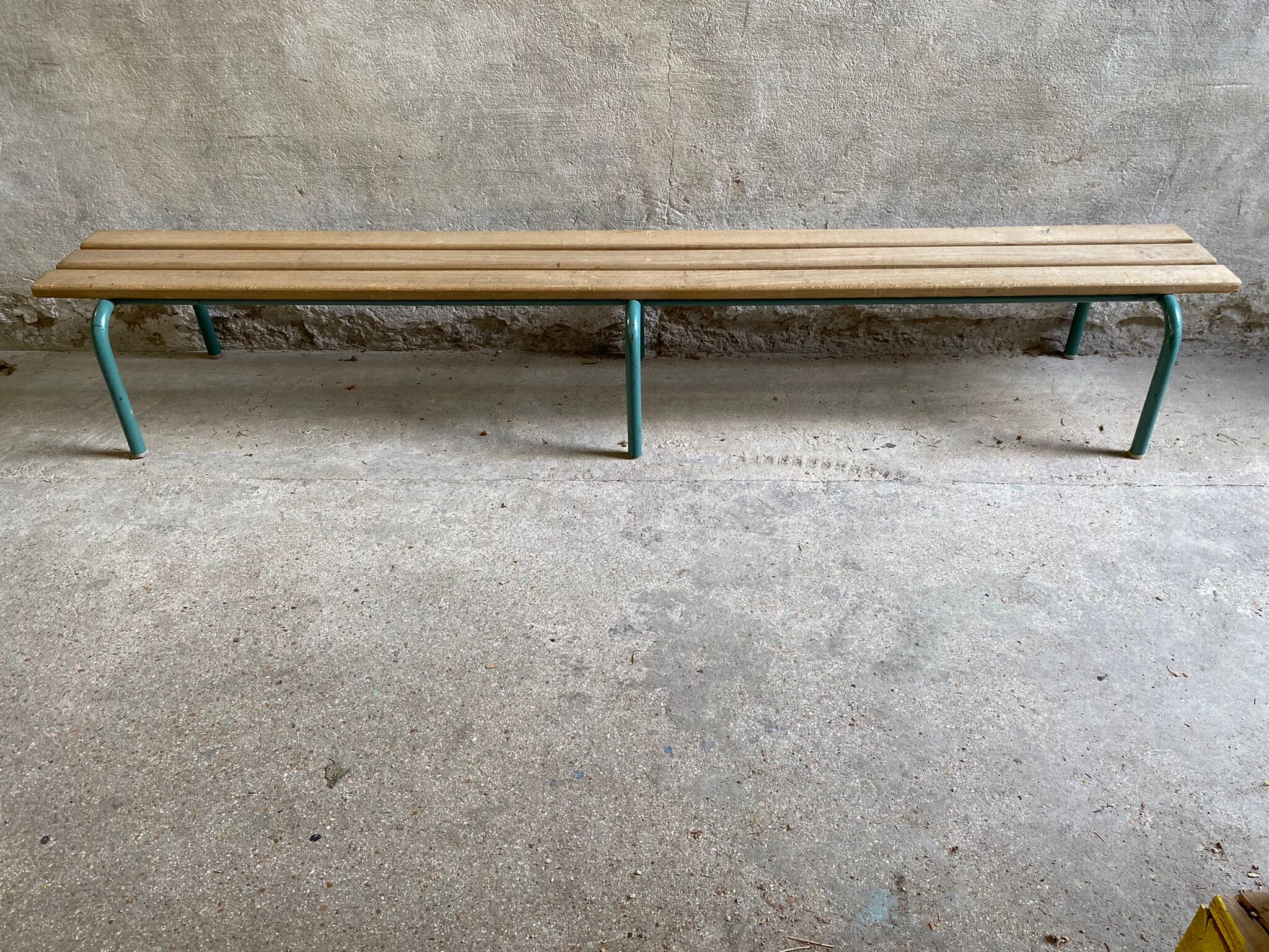 Vintage wood kindergarten bench and tubular structure in long