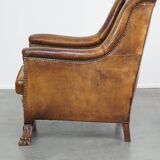 Characteristic antique sheepskin leather armchair with beautiful details and a unique design