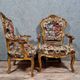 Pair of Louis XV style Baroque armchairs in gilded and carved wood circa 1900