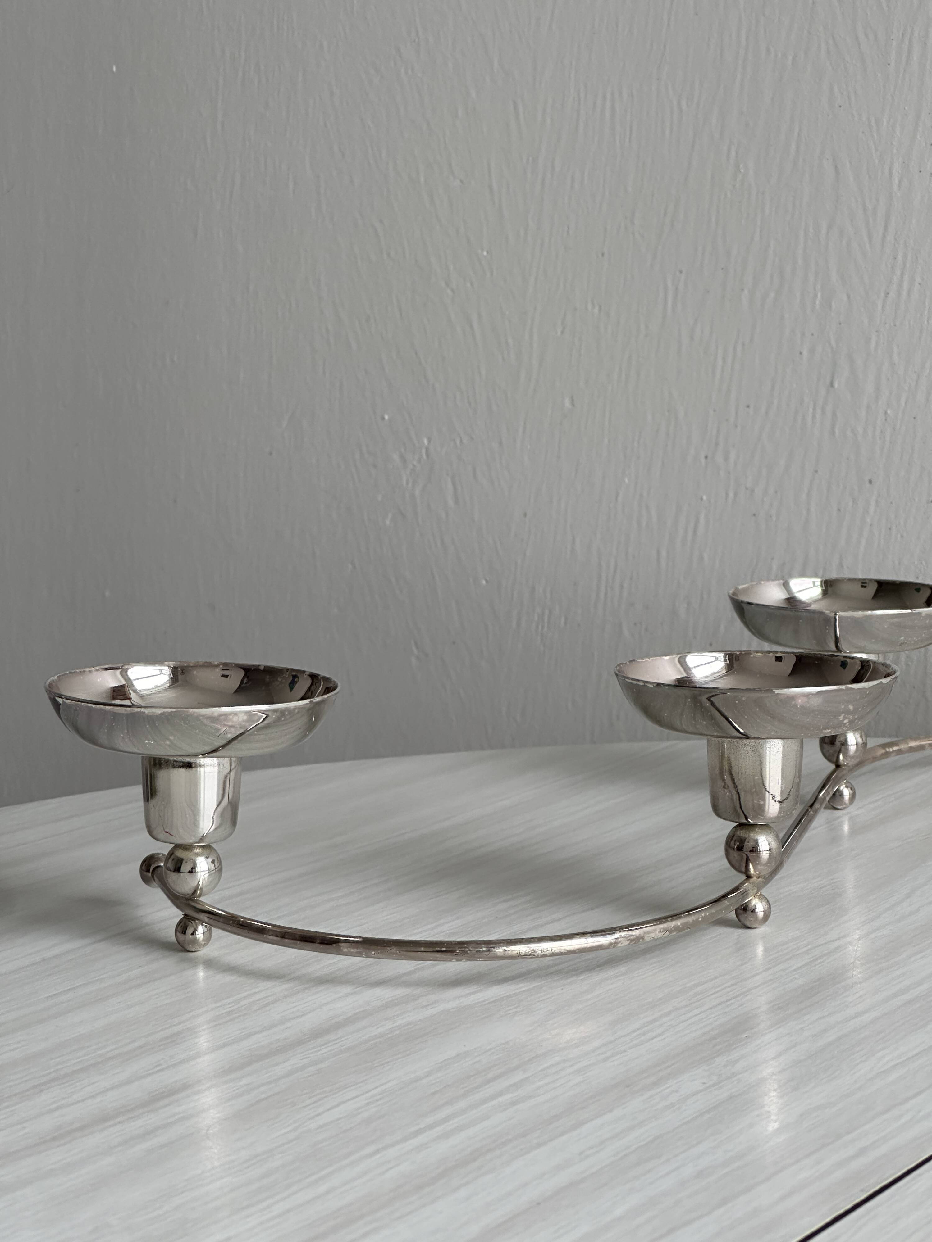 Shiny stainless steel candlestick holder