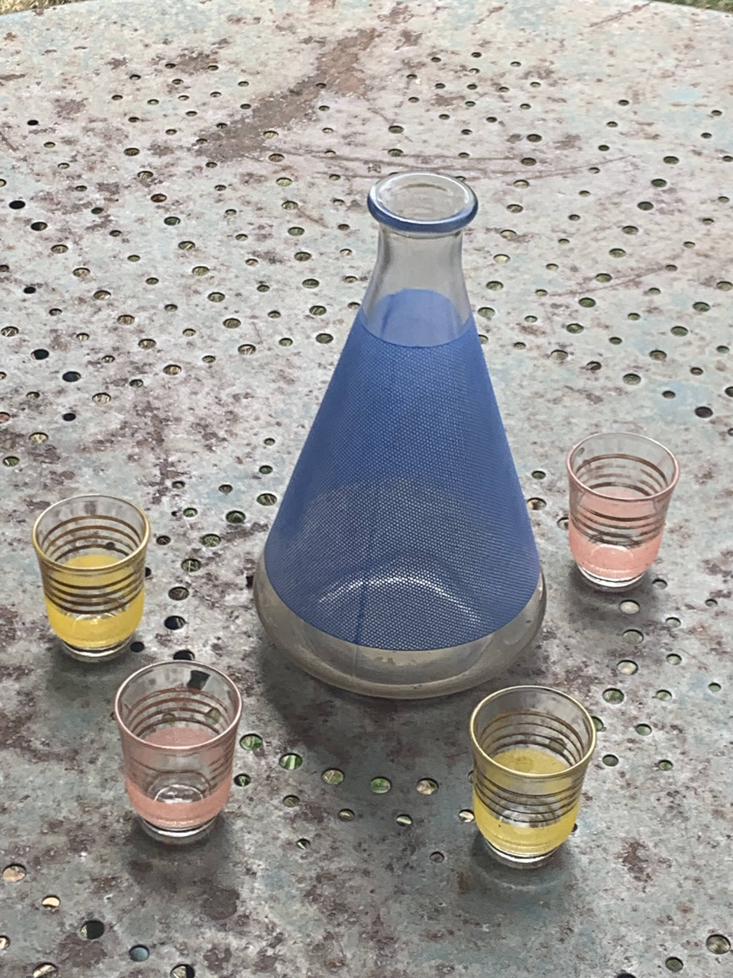 Blue glass liqueur carafe and 4 small vintage granite glasses