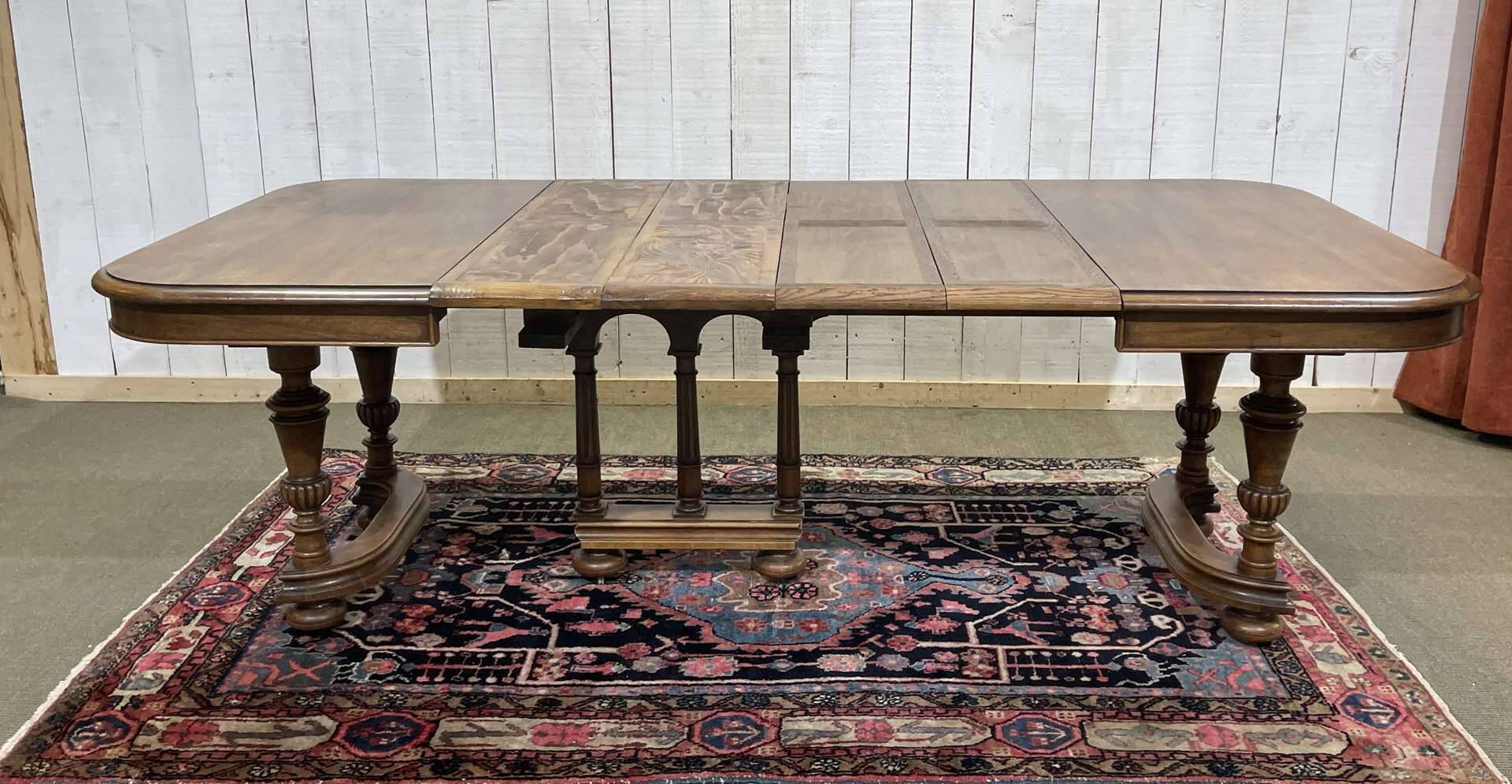 Henri II walnut table from the early 20th century with extensions.