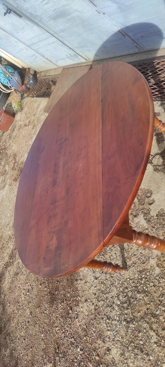 Old extendable round table in fruit wood with folding sides