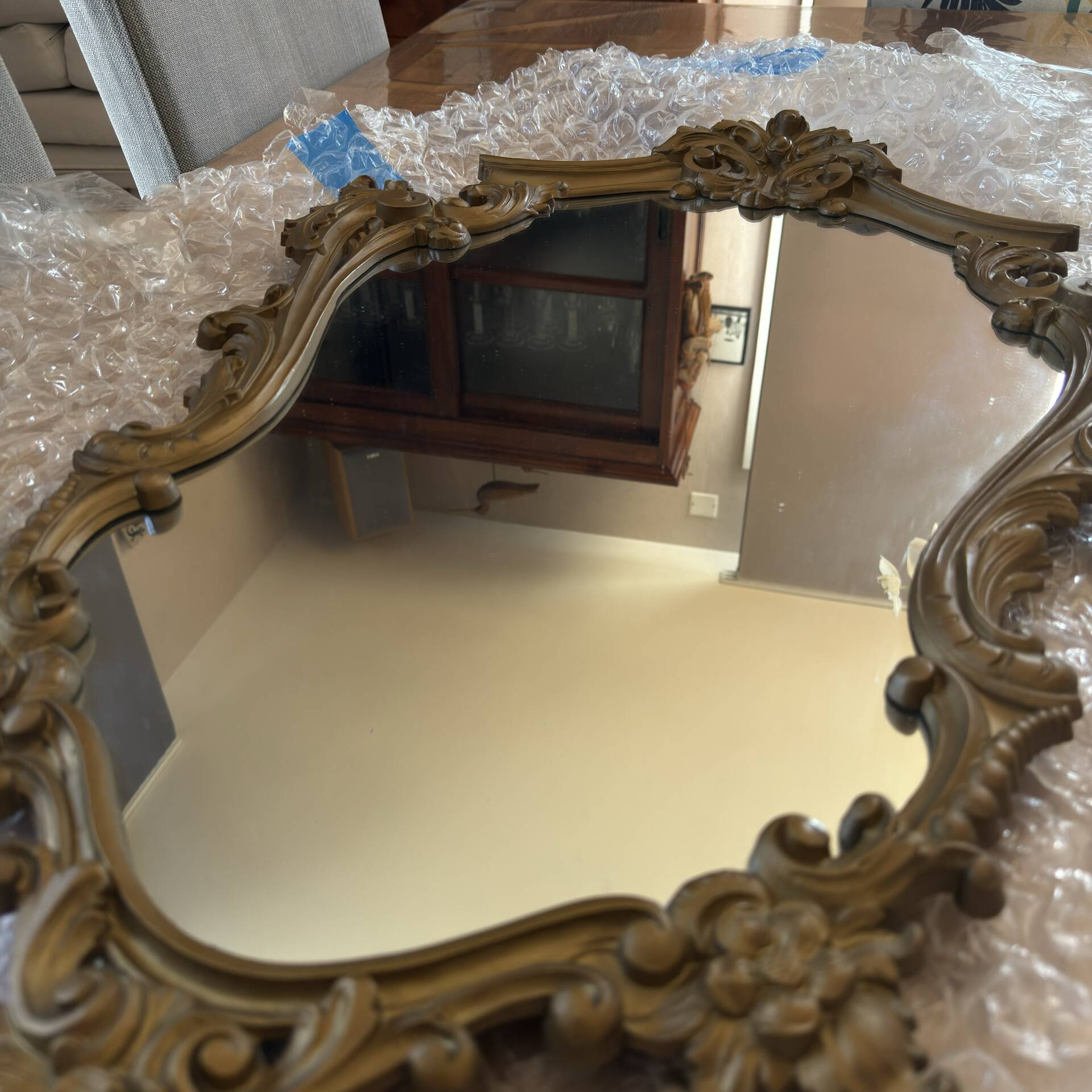 Antique mirror in Louis XV Rocaille style with carved frame.