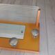 1950s coat rack with mirror, metal hooks, and glass shelf.