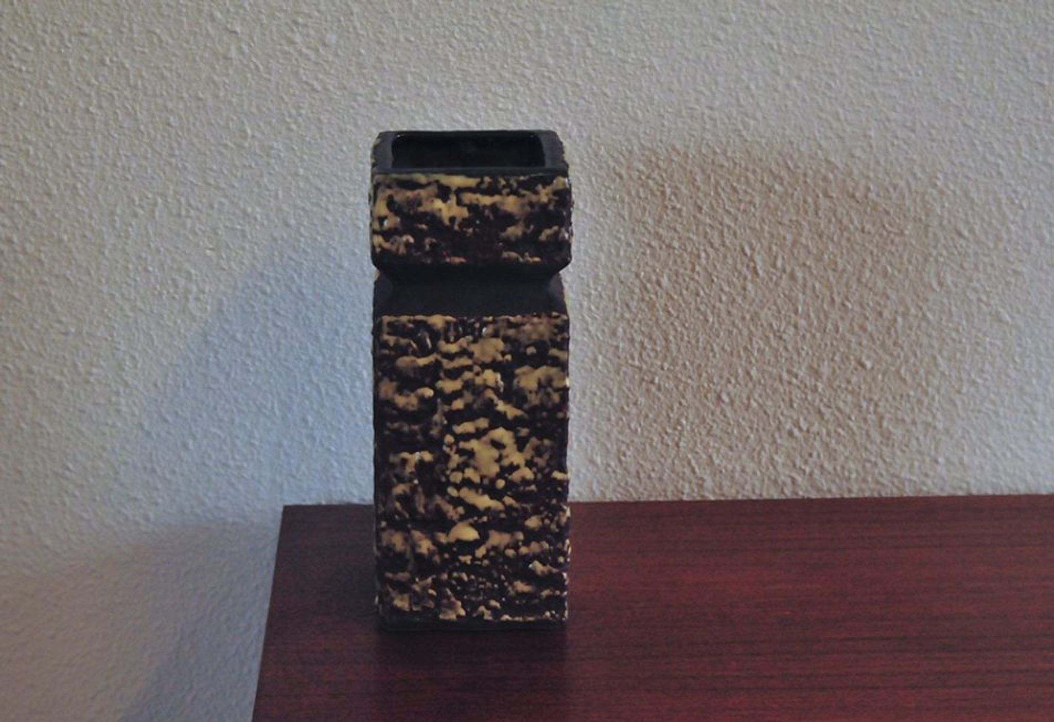Vintage brown vase in yellow relief.