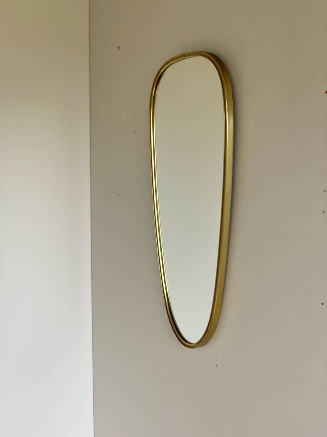 Vintage brass mirror in rear-view mirror shape